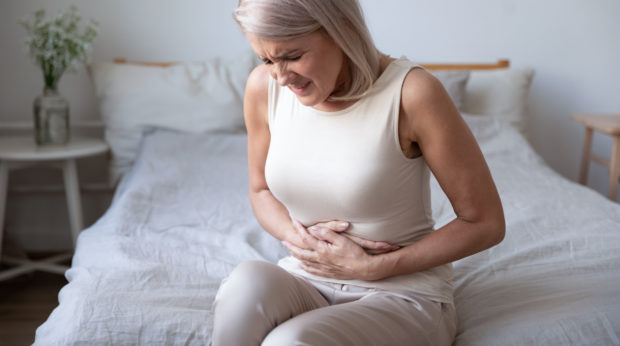 Unhealthy,Mature,Woman,Holding,Belly,,Feeling,Discomfort,,Health,Problem,Concept, Outbreak of ulcerative colitis